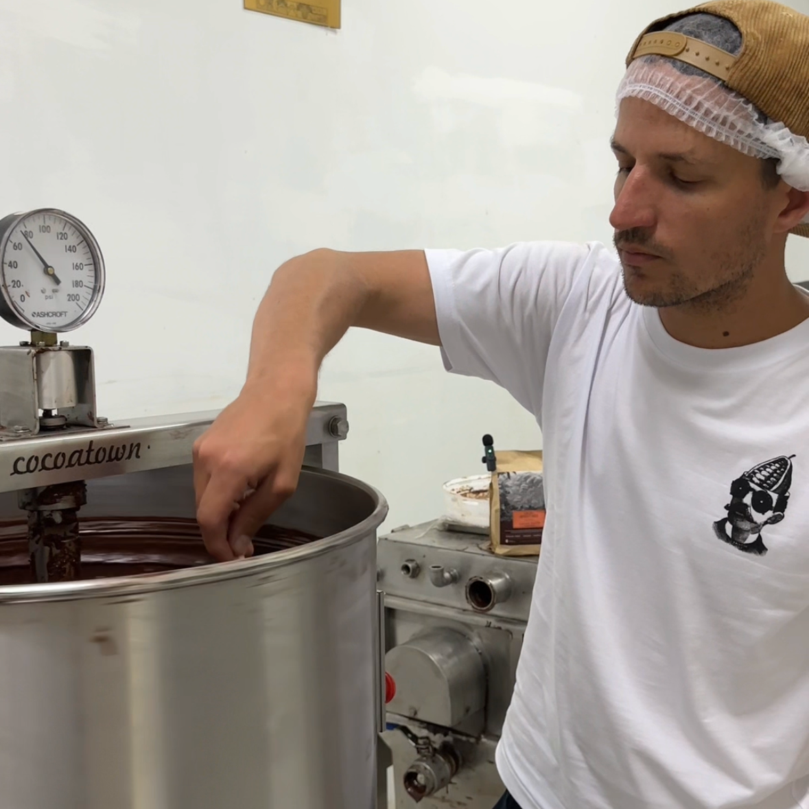 Jose working with the melanger making chocolate